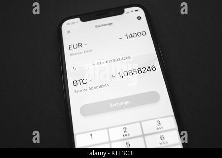 KAUNAS, LITHUANIA - DECEMBER 23, 2017: Exchange rate of Bitcoin. View of Revolut app on iPhone X screen. Crypto currencies concept. Stock Photo