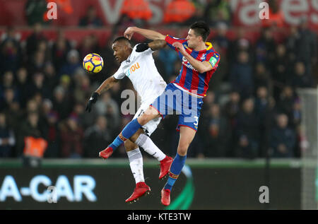Crystal Palace's Martin Kelly (right) and Swansea City's Jordan Ayew battle for the ball during the Premier League match at the Liberty Stadium, Swansea.