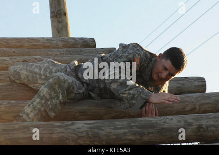 Sgt. Wesley Keesee, 258th Military Police Company, 519th Military Police Battalion, weaves himself in and out of 'the weaver' obstacle June 8. Stock Photo