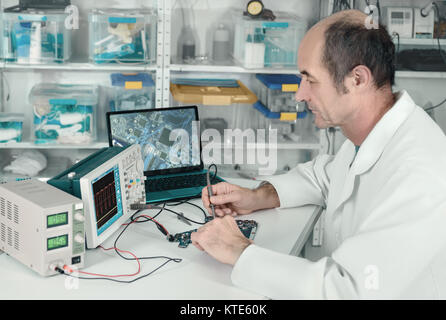 Senior male tech is working in hardware repair facility Stock Photo