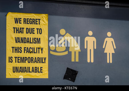Vandalised baby changing and public toilet notice. We regret that due to vandalism this facility is temporarily unavailable sign. Toilets. Graphics Stock Photo