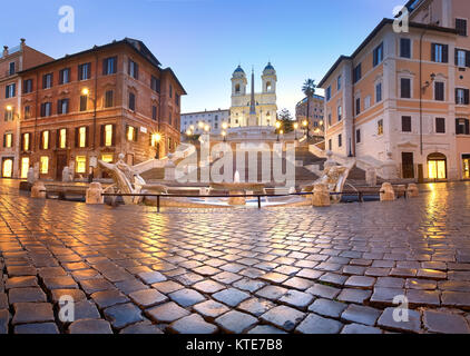 Spanish Steps and a boat-shaped fountain on Piazza di Spagna in Rome, Italy. Early morning panoramic shot after rain. Stock Photo