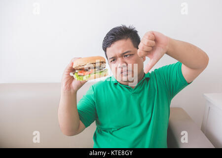 Overweight man stop eating junk food Stock Photo