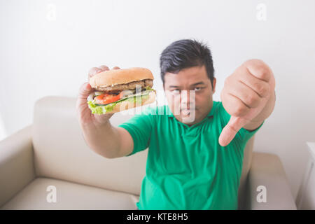 Overweight man stop eating junk food Stock Photo