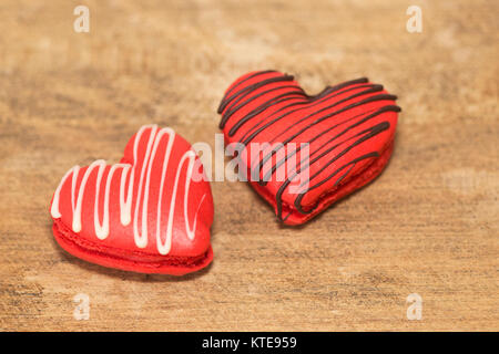 Two heart-shaped macarons drizzled with chocolate made for Valentine's Day Stock Photo