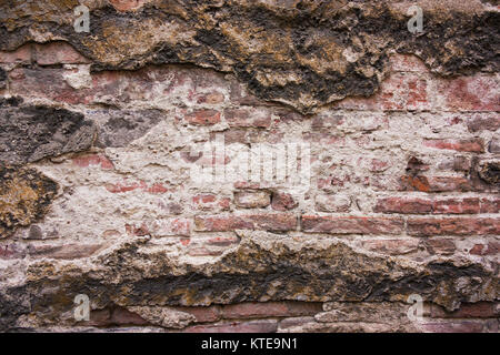 The old wall of the destroyed, dirty cement, plaster and brick. Stock Photo
