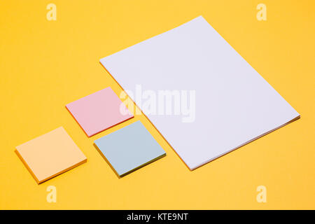The many empty paper clips, yellow background Stock Photo