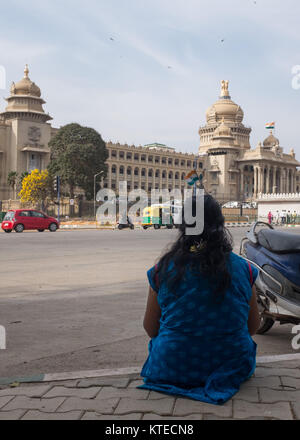 Female demonstrator in front of Vidhana Soudha, the Karnataka state legislative assembly, Bangalore, India. Stock Photo