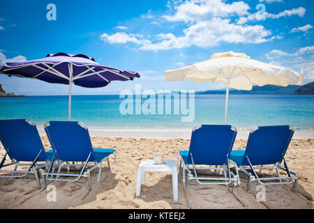 Deckchair on beautiful Lichnos beach near Parga village, Greece. Stock Photo