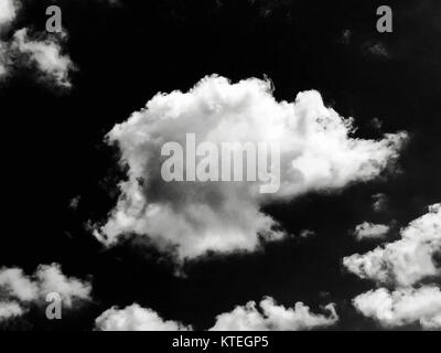 Isolated white clouds on black sky. Set of isolated clouds over black background. Design elements. White isolated clouds. Cutout extracted clouds. Stock Photo