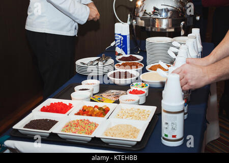 The chef prepares the dessert waffles Stock Photo