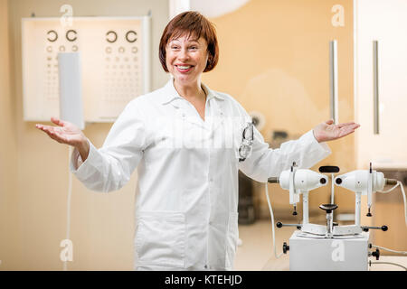 Portrait of a senior woman doctor in uniform standing in the ophthalmologic office Stock Photo