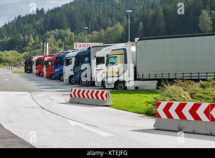 HAUS, AUSTRIA - SEPTEMBER 24, 2017: Parked trucks lined up at the Landzeit highway rest stop in Austrian Alps. Stock Photo