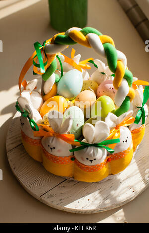 Easter decorations - textile basket with rabbits and eggs, morning light from window Stock Photo