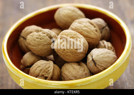 whole walnuts in bowl Stock Photo