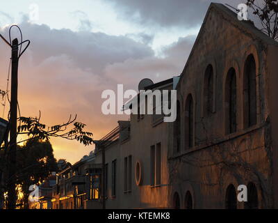 A colorful picture taken during evening time of a picturesque urban street that has a rustic character Stock Photo