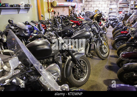 ST. PETERSBURG, RUSSIA-CIRCA OCT, 2016: Two-wheeled motor vehicles as motorcycles and scooters are ready for overwintering in warehouse in Motozastava Stock Photo