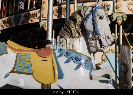 White horse with yellow saddle on a french merry-go-round Stock Photo