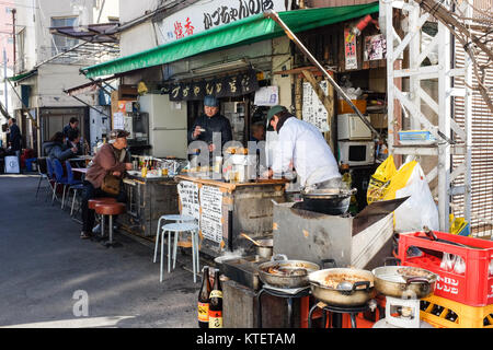 A small restaurant near Asakusa in Tokyo, Japan, where people can also dine on tables outside. Stock Photo