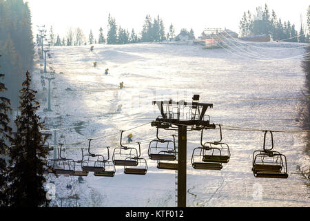 Ski lift with empty seats over the snow mountain in ski resort Stock Photo