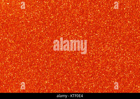 Orange glitter texture on macro. Stock Photo