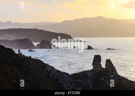 Solo traveller looking at the sunset at the Loiba cliffs (Acantilados de Loiba) Coruña province, Galicia, Spain, Europe Stock Photo