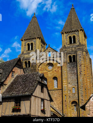 Conques medieval abbey-church front with blue sky on background, France Stock Photo