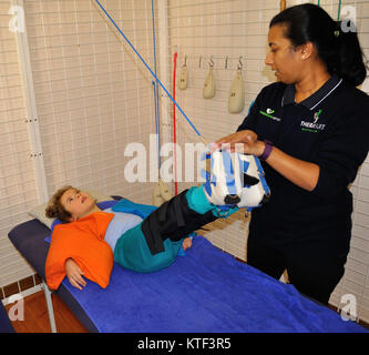 ADELAIDE, AUSTRALIA, MAY 25, 2017: A therapist works with a girl who has cerebral palsy. Stock Photo