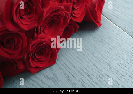 red roses on light blue wood background Stock Photo