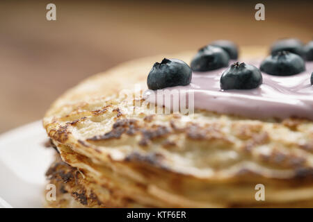 blini or crepes with yogurt and blueberries closeup Stock Photo