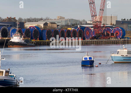 Cable bobbins and tug on River Tyne dockside near Wallsend, Tyne and Wear Stock Photo