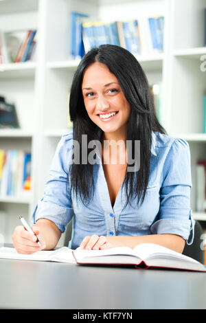 Happy student learning in library Stock Photo