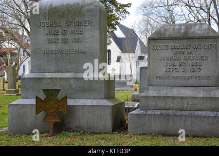 An old weathered CSV Iron Cross signifying the grave site of a confederate solder at a rural southern church cemetery Stock Photo