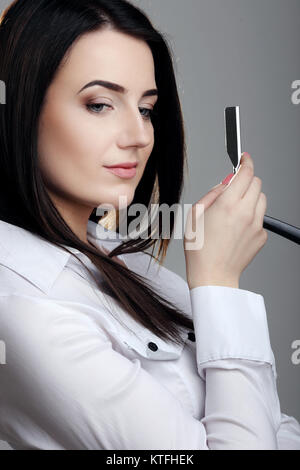 Professional hairdresser with her tools, isolated on grey Stock Photo