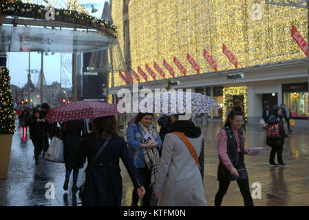 Glasgow, Scotland, UK  24th December.UK Weather: Rain and wind greet the last minute Christmas Eve shoppers to Buchanan street, Glasgow's style mile from Frasers or the streets to princes square shopping centre. Credit Gerard Ferry/Alamy news Stock Photo