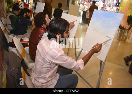 QUETTA, PAKISTAN. Dec-24 2017:  Artists from different academies and art centrers drawing the painting during Fine Arts competition Drought Resilient Agriculture Modelling at millennium mall in Quetta Pakistan. Organized by Islamic Relief Stock Photo