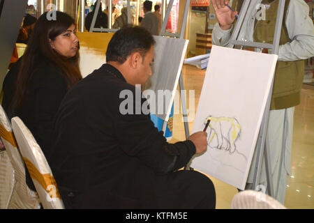 QUETTA, PAKISTAN. Dec-24 2017:  Artists from different academies and art centrers drawing the painting during Fine Arts competition Drought Resilient Agriculture Modelling at millennium mall in Quetta Pakistan. Organized by Islamic Relief Stock Photo