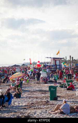 Cocoa Beach, Florida, USA. 24th Dec, 2017. Surfing Santas, an annual surf event taking place on Christmas Eve in Cocoa Beach, Florida where people dressed in Santa Claus costumes surf. Credit:  Lori Barbely/Alamy Live News Stock Photo