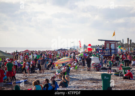 Cocoa Beach, Florida, USA. 24th Dec, 2017. Surfing Santas, an annual surf event taking place on Christmas Eve in Cocoa Beach, Florida where people dressed in Santa Claus costumes surf. Credit:  Lori Barbely/Alamy Live News Stock Photo