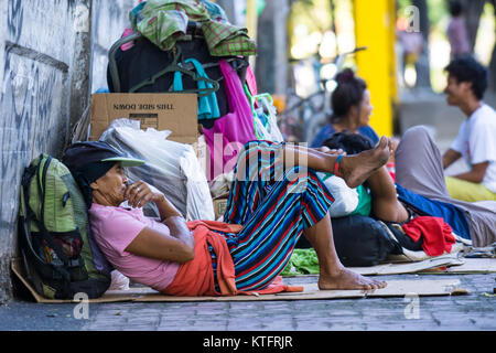 Cebu City, Philippines. 25th Dec, 2017. Homeless people along the sidewalk of a main street on Christmas day morning 2017,Cebu City,Philippines Credit: imagegallery2/Alamy Live News Stock Photo