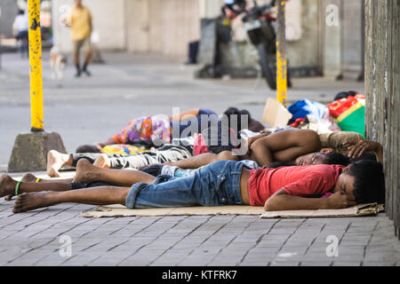 Cebu City, Philippines. 25th Dec, 2017. Homeless people along the sidewalk of a main street on Christmas day morning 2017,Cebu City,Philippines Credit: imagegallery2/Alamy Live News Stock Photo