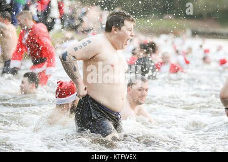 Sutton Coldfield, West Midlands, UK. 25th December, 2017. Scores of people turn out for the traditional Christmas Day swim in Blackroot Pool, in Sutton Park, Sutton Coldfield. Stock Photo