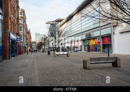 Manchester UK; 25th. December 2017: Manchester rough sleepers in Manchester on Christmas Day. A deserted Market Street in Manchester city centre on Christmas day with rough sleepers sheltering in doorways. Usually a very busy shopping area. Scores of homeless rough sleepers spending their Christmas Day huddled in shop doorways. Several passers by stopped to speak with them, some offering coffee and food from nearby branches of Starbucks while a mother and daughter parked their van in Piccadilly to hand out clothes to the homeless from the back of their van. Stock Photo