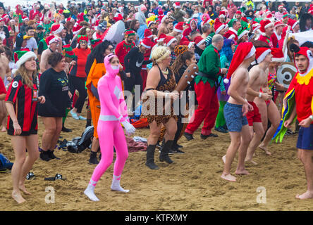 Boscombe, Bournemouth, Dorset, UK. Christmas Day 25th December 2017. Brave volunteers plunge into the cold choppy sea for a swim, for the 10th annual charity White Christmas Dip, dressed in fancy dress costumes and raising money for Macmillan Caring Locally at Christchurch, a Specialist Palliative Care Unit for patients in the local community. Hundreds take part in the event which has become a popular tradition for many before their Christmas lunch. Credit: Carolyn Jenkins/Alamy Live News Stock Photo