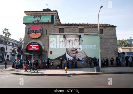 Los Angeles, USA. 25th Dec, 2017. People line up on Christmas day for a free meal beneath a billboard of Jerry Seinfeld with a tooth pick at the Laugh Factory on the Sunset Strip in Los Angeles. Credit: Robert Landau/Alamy Live News Stock Photo