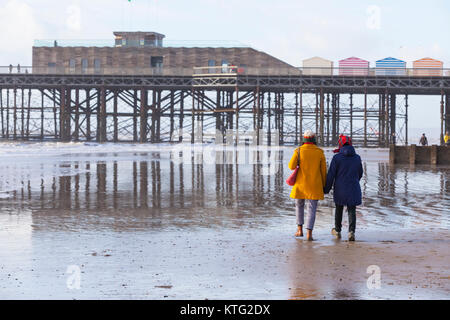 Hastings, East Sussex, UK. 26th December 2017. A mild and sunny day on Boxing Day. The tide is out and lots of people are walking near the award winning pier in Hastings this morning. Photo Credit: Paul Lawrenson/ Alamy Live News Stock Photo