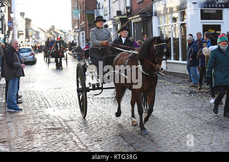 Horses and carriages follow the The Albrighton Hunt Boxing Day hunt meet at Newport in Shropshire Uk. Credit: David Bagnall Stock Photo