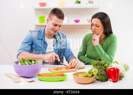 Young couple cooking in their kitchen. Stock Photo