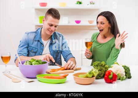 Young couple cooking in their kitchen. Stock Photo