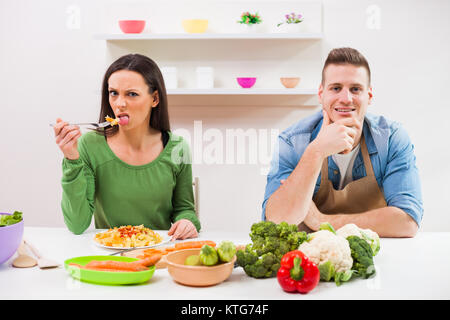 Young couple cooking in their kitchen. Stock Photo